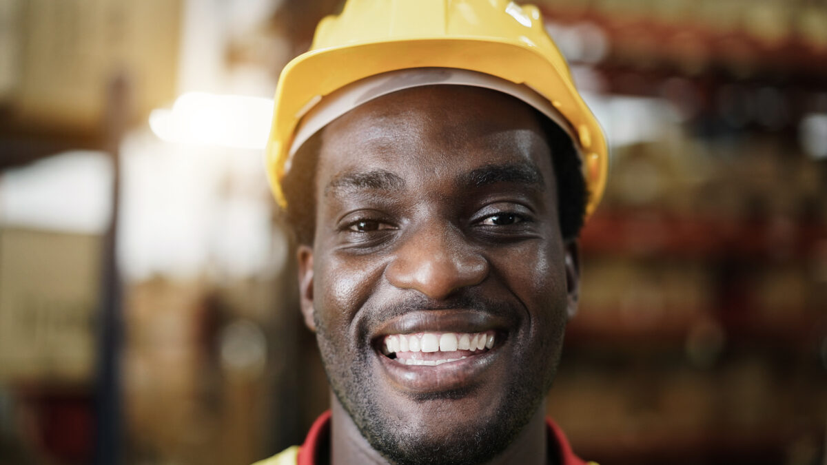 Happy manual labour worker in warehouse