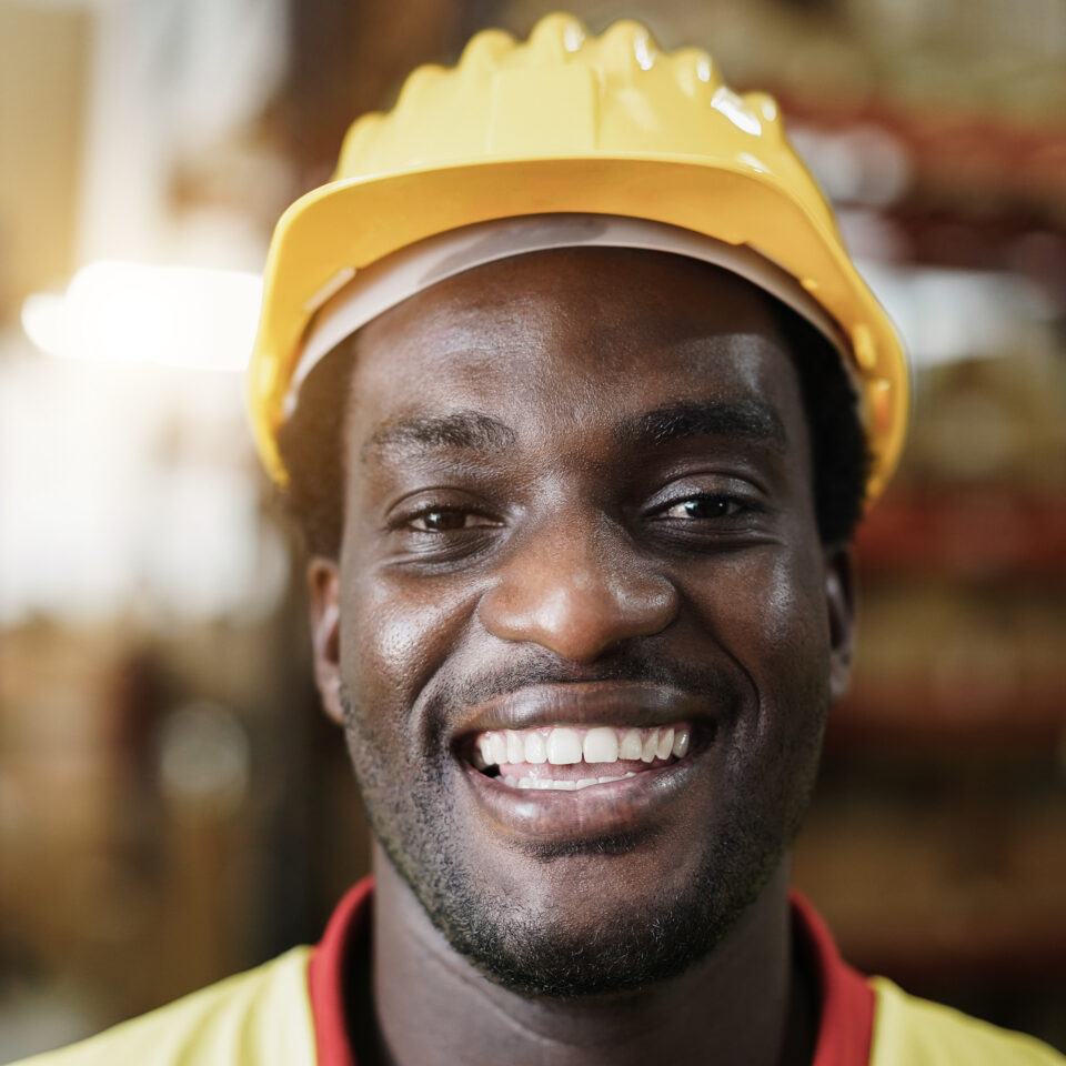 Happy manual labour worker in warehouse
