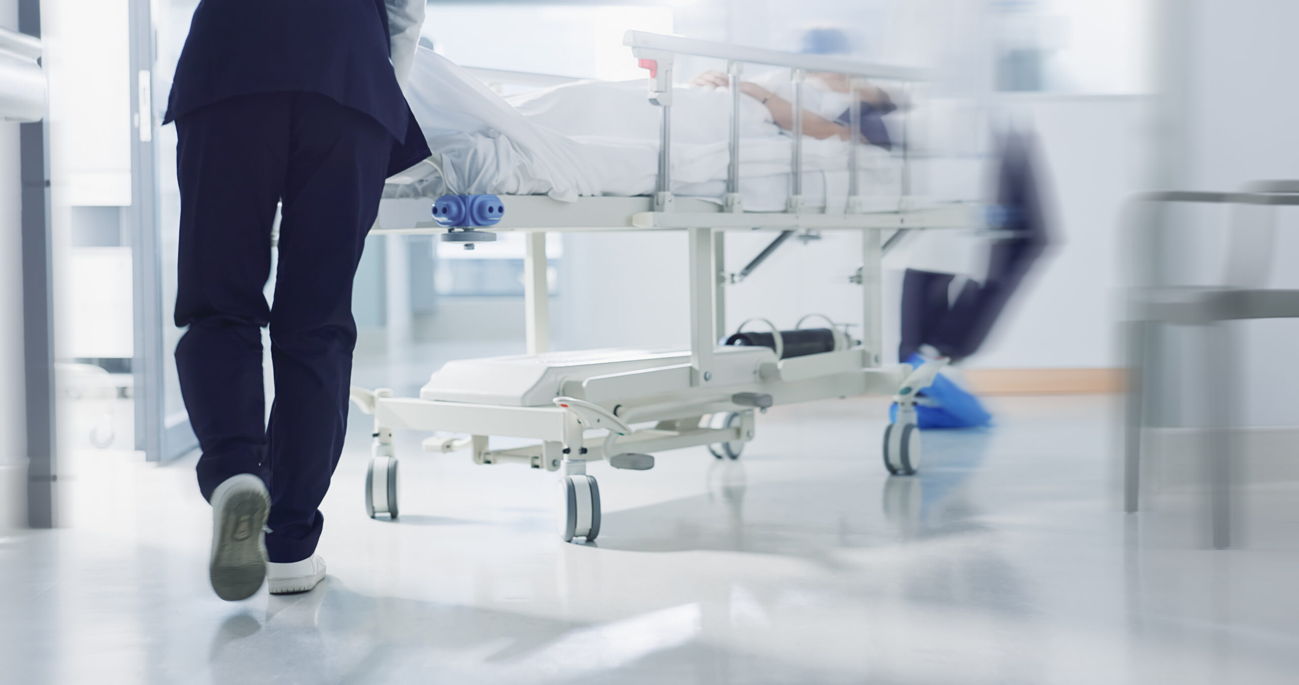 Image of hospital staff feet as they push a patient.