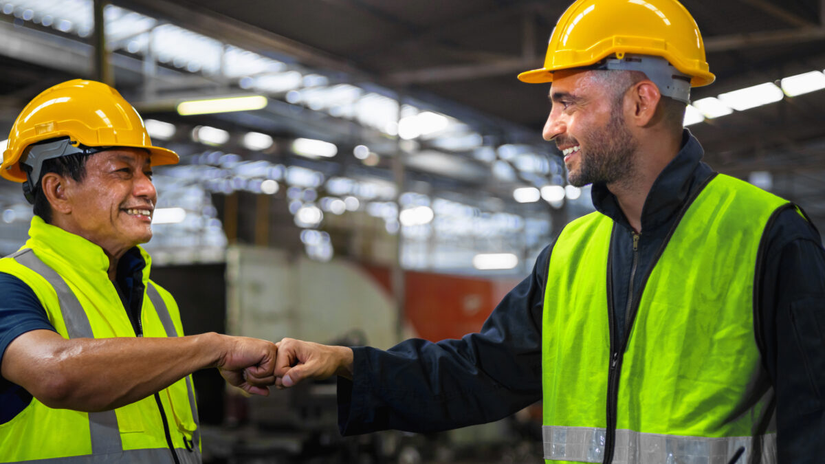 Supervisor greets worker with a fist bump, showing support and empathy.