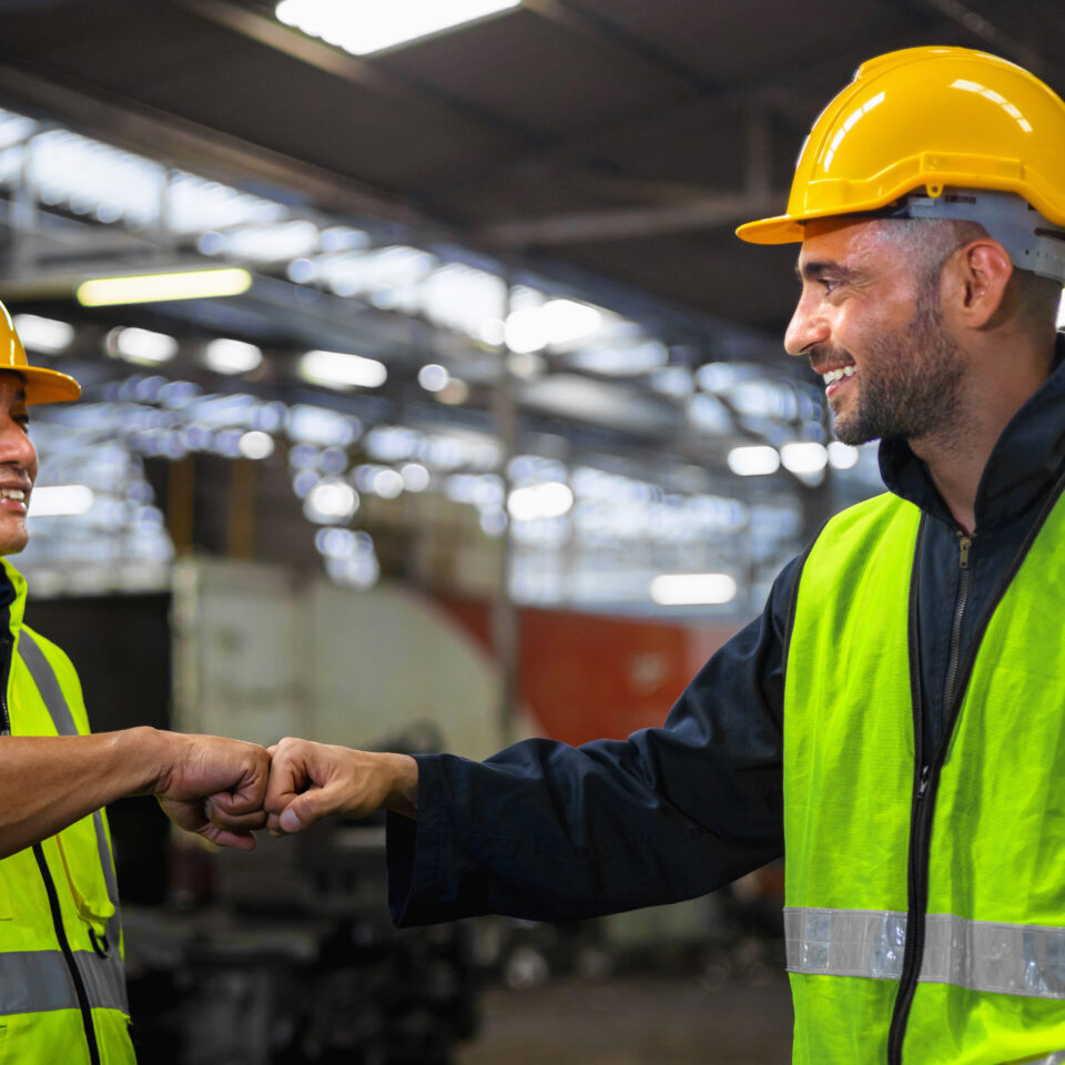 Supervisor greets worker with a fist bump, showing support and empathy.